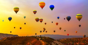 Hot air balloons landing in a mountain Cappadocia Goreme National Park Turkey.